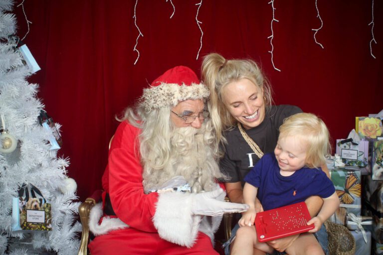 Santa giving a gift to a child at an event